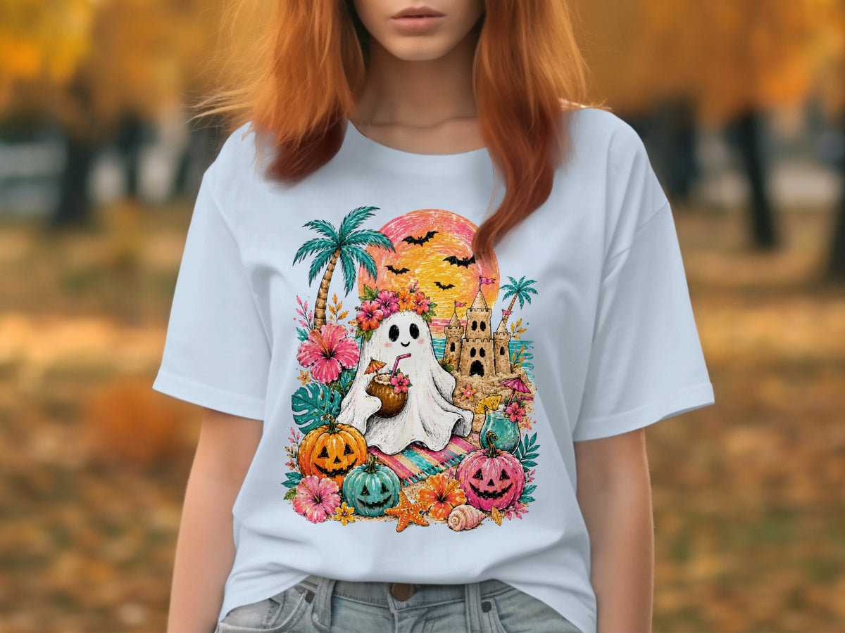 White t-shirt with a Hawaiian-themed Halloween graphic featuring a ghost, pumpkins, and a sandcastle.